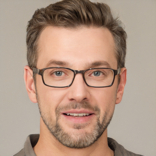 Joyful white adult male with short  brown hair and grey eyes