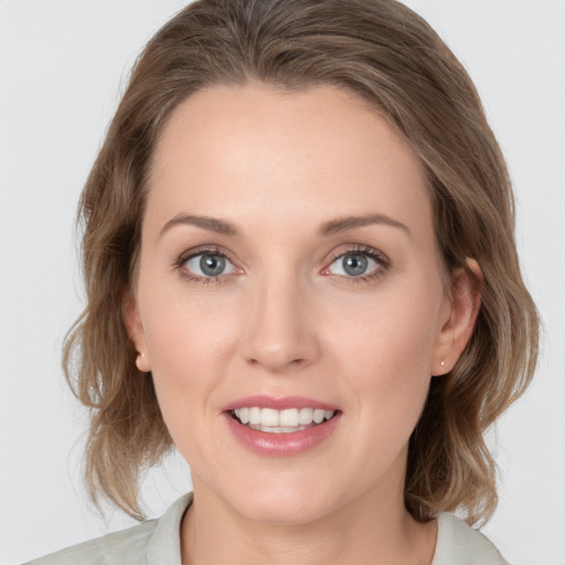 Joyful white young-adult female with medium  brown hair and blue eyes