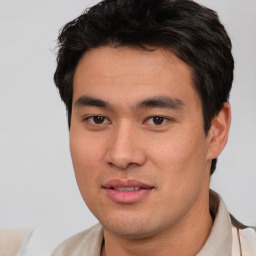 Joyful asian young-adult male with short  brown hair and brown eyes