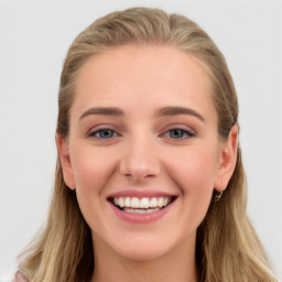 Joyful white young-adult female with long  brown hair and blue eyes