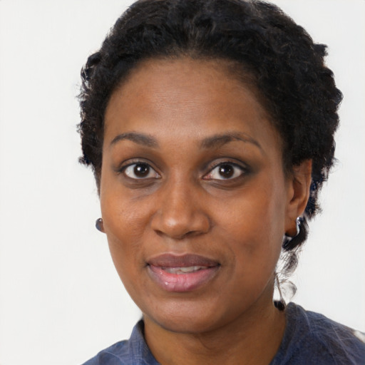 Joyful black adult female with short  black hair and brown eyes