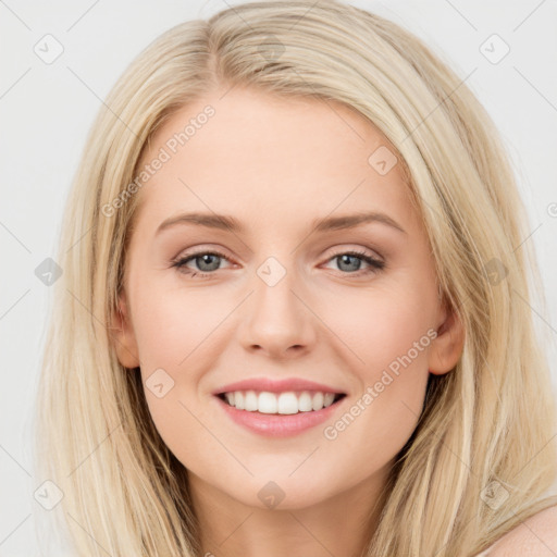 Joyful white young-adult female with long  brown hair and blue eyes