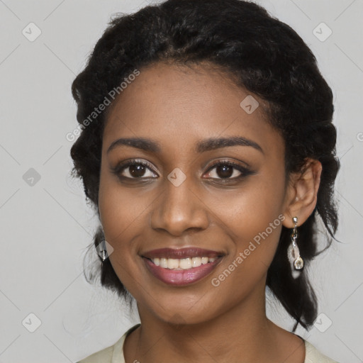 Joyful black young-adult female with long  black hair and brown eyes