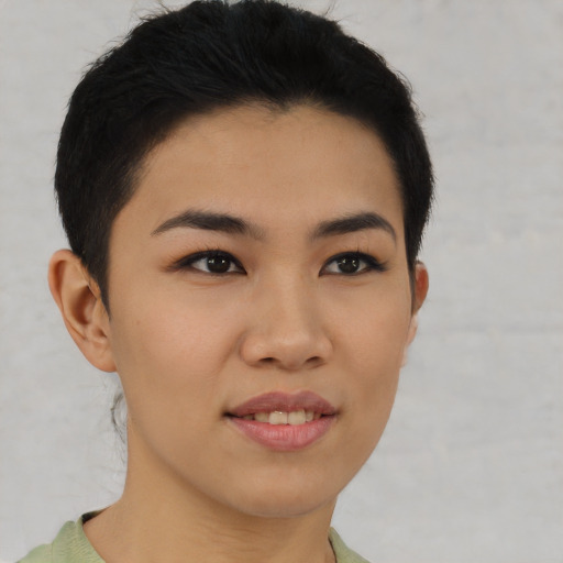 Joyful asian young-adult female with short  brown hair and brown eyes