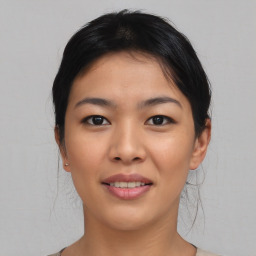 Joyful asian young-adult female with medium  black hair and brown eyes