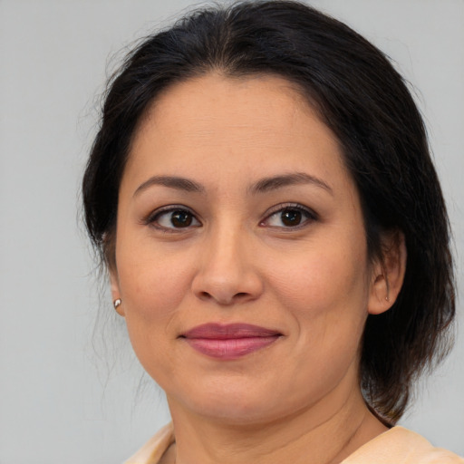 Joyful white adult female with medium  brown hair and brown eyes