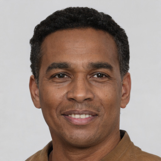 Joyful latino adult male with short  black hair and brown eyes