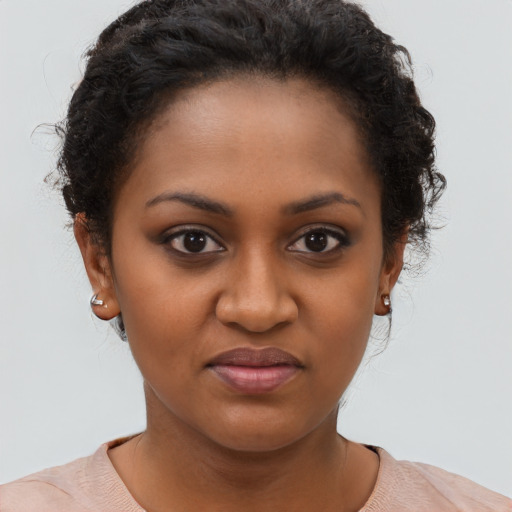 Joyful black young-adult female with short  brown hair and brown eyes