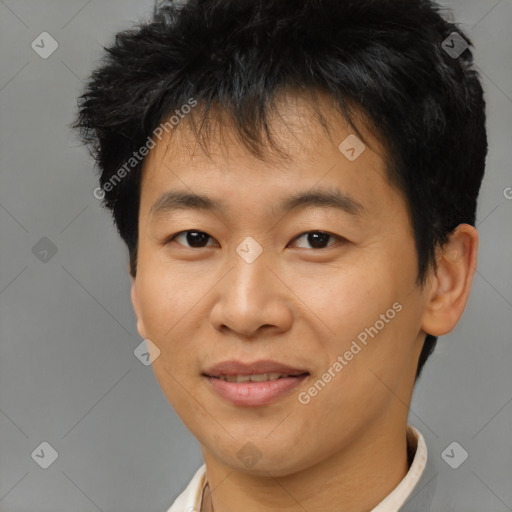 Joyful asian young-adult male with short  brown hair and brown eyes