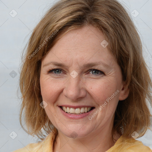 Joyful white adult female with medium  brown hair and blue eyes