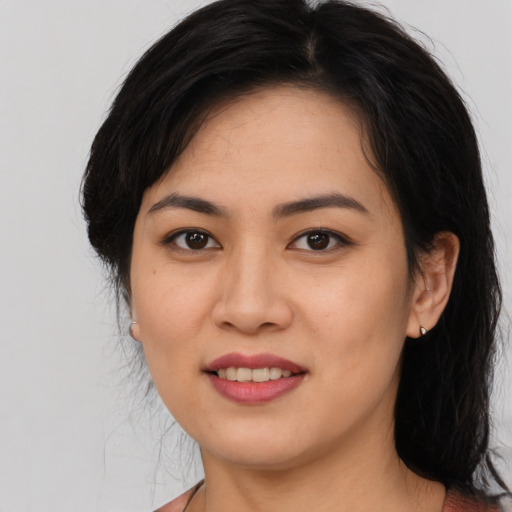 Joyful asian young-adult female with long  black hair and brown eyes