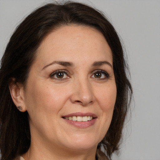 Joyful white adult female with medium  brown hair and brown eyes