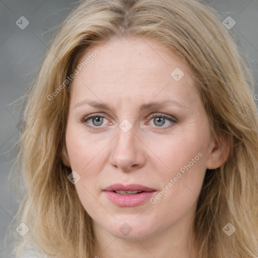 Joyful white adult female with medium  brown hair and blue eyes