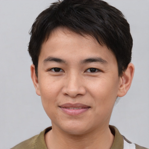 Joyful asian young-adult male with short  brown hair and brown eyes