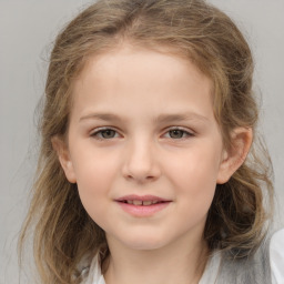 Joyful white child female with medium  brown hair and grey eyes