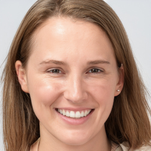 Joyful white young-adult female with long  brown hair and grey eyes