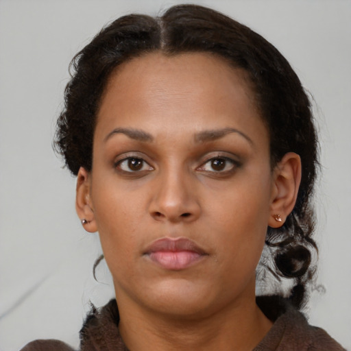 Neutral black young-adult female with medium  brown hair and brown eyes