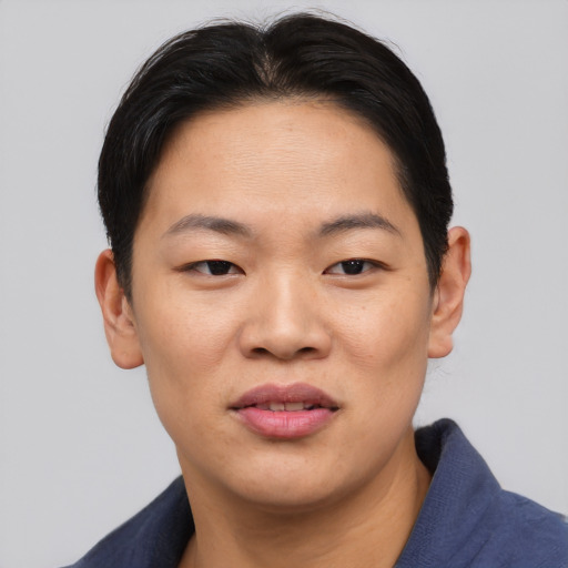 Joyful asian young-adult female with short  black hair and brown eyes