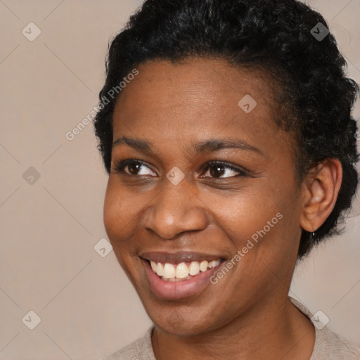 Joyful black young-adult female with short  brown hair and brown eyes