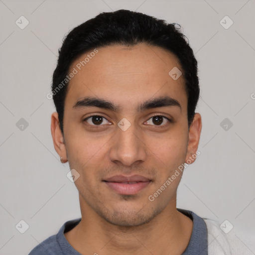 Joyful latino young-adult male with short  black hair and brown eyes