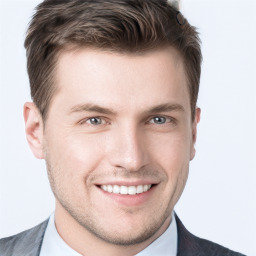 Joyful white young-adult male with short  brown hair and grey eyes