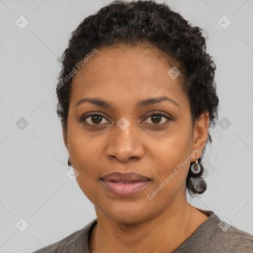 Joyful black adult female with short  black hair and brown eyes