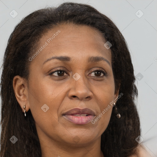 Joyful black adult female with long  brown hair and brown eyes