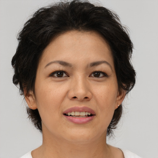 Joyful asian adult female with medium  brown hair and brown eyes