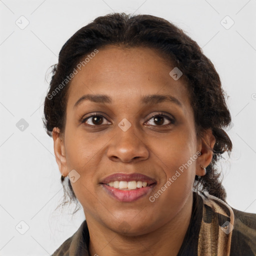 Joyful black adult female with long  brown hair and brown eyes