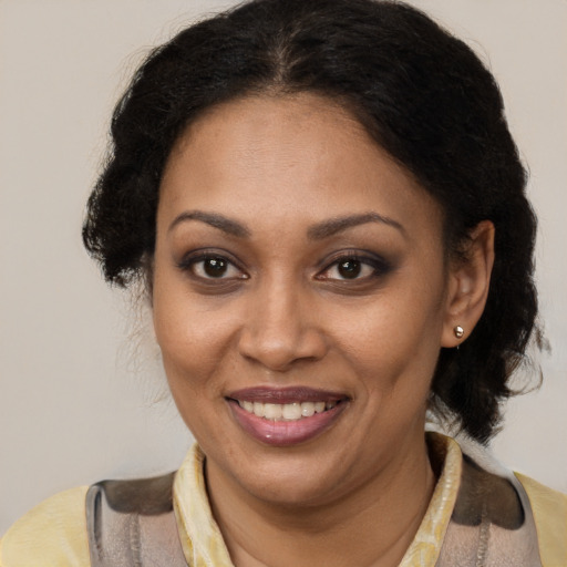Joyful black young-adult female with medium  brown hair and brown eyes