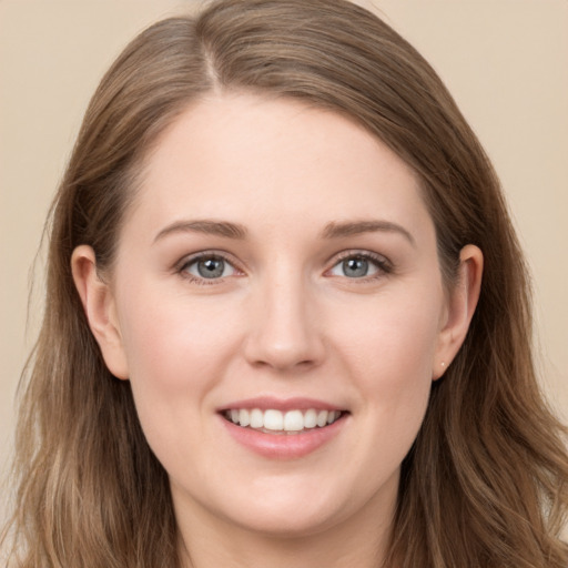 Joyful white young-adult female with long  brown hair and grey eyes