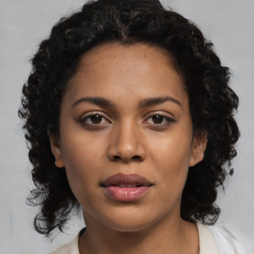 Joyful latino young-adult female with medium  black hair and brown eyes