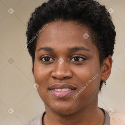 Joyful black young-adult female with short  black hair and brown eyes