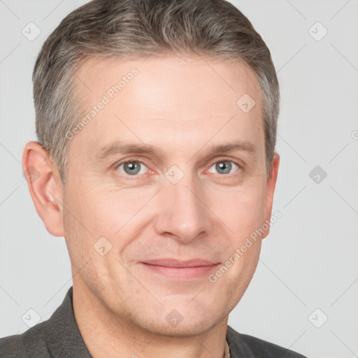 Joyful white adult male with short  brown hair and grey eyes