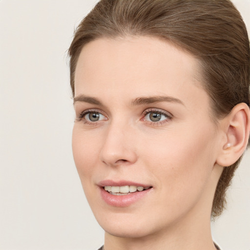 Joyful white young-adult female with long  brown hair and grey eyes