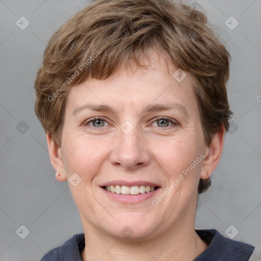 Joyful white adult female with short  brown hair and grey eyes