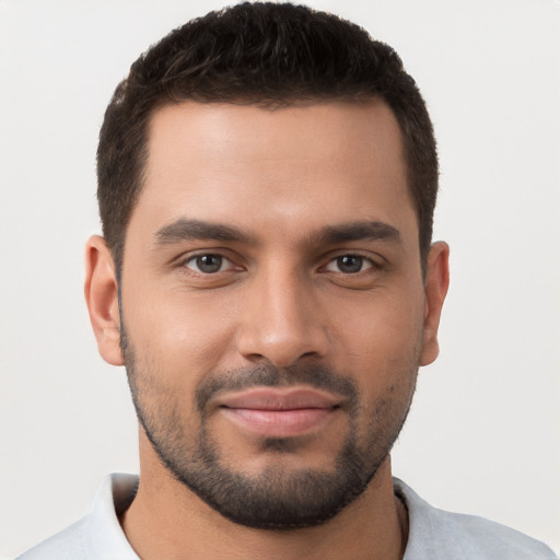 Joyful white young-adult male with short  brown hair and brown eyes