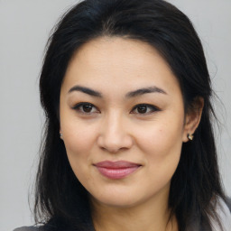 Joyful asian young-adult female with long  brown hair and brown eyes