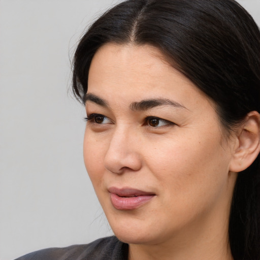 Joyful white young-adult female with medium  black hair and brown eyes
