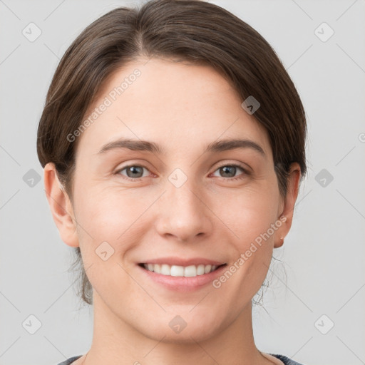 Joyful white young-adult female with short  brown hair and grey eyes