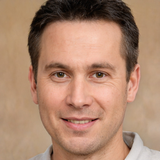 Joyful white adult male with short  brown hair and brown eyes