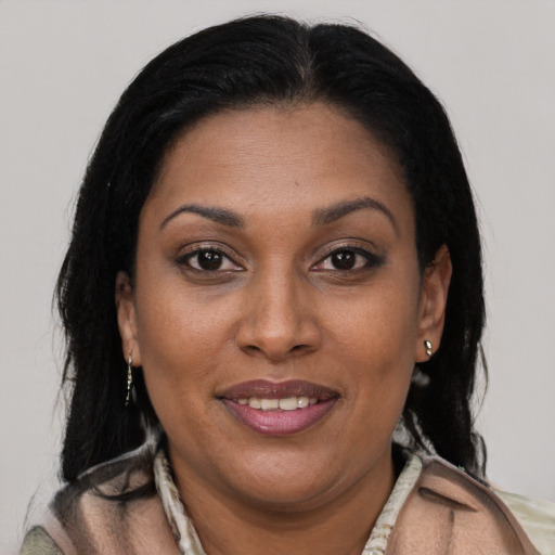 Joyful latino adult female with long  brown hair and brown eyes