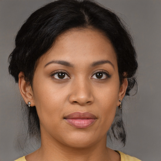 Joyful latino young-adult female with medium  brown hair and brown eyes