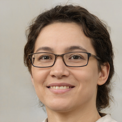 Joyful white adult female with medium  brown hair and brown eyes