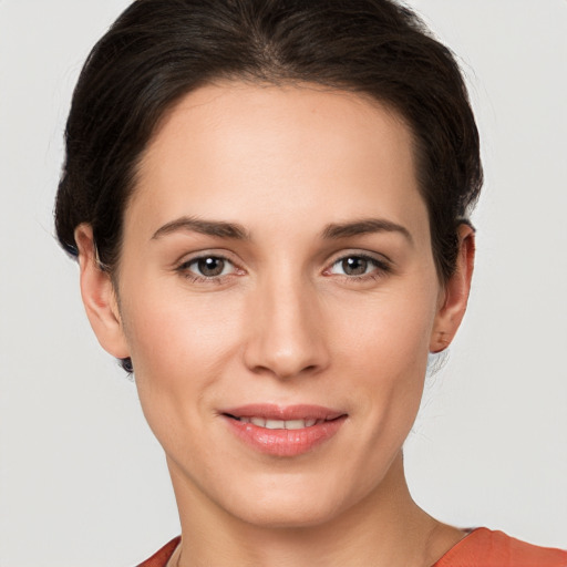 Joyful white young-adult female with short  brown hair and grey eyes