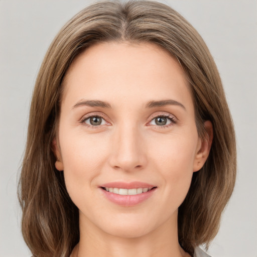 Joyful white young-adult female with medium  brown hair and green eyes