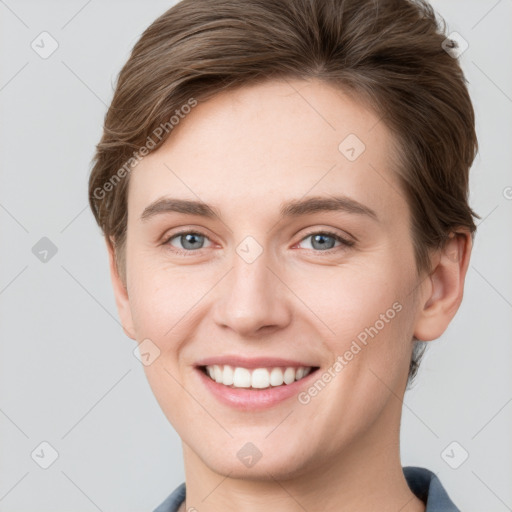 Joyful white young-adult female with short  brown hair and grey eyes