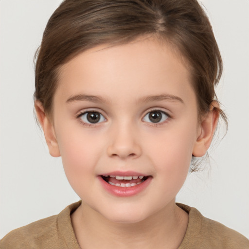 Joyful white child female with short  brown hair and brown eyes