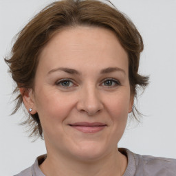 Joyful white adult female with medium  brown hair and brown eyes