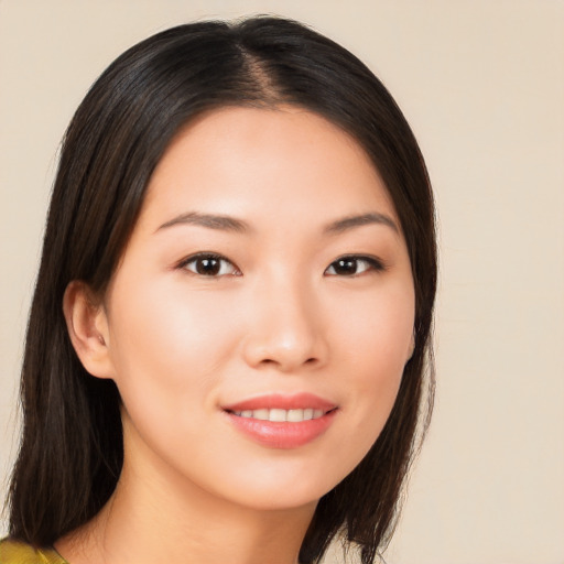 Joyful asian young-adult female with long  brown hair and brown eyes